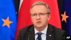 FILE - Krzysztof Szczerski, the foreign policy adviser of Polish President Andrzej Duda, speaks during a news conference at the Presidential Palace in Warsaw, Poland, Aug. 17, 2015.