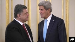 Ukrainian President Petro Poroshenko, left, shakes hands with U.S. Secretary of State John Kerry during a meeting in Kyiv, Feb. 5, 2015.