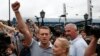 Russian opposition leader Alexei Navalny (L) addresses his supporters after arriving from Kirov, with his wife, Yulia, standing nearby, at a railway station in Moscow, July 20, 2013.