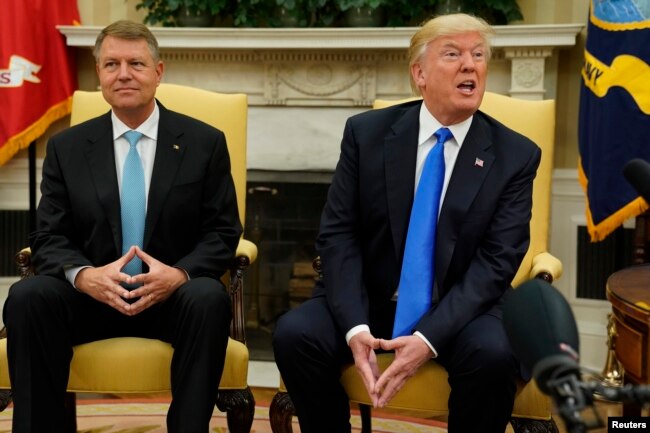 U.S. President Donald Trump, right, responds to a question as he meets with Romanian President Klaus Iohannis in the Oval Office at the White House in Washington, U.S. June 9, 2017.