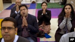 In this Jan. 17, 2016 photo, Ruma Roka, second from right, who runs an institute for young people with hearing impairment, joins a Buddhist chanting session in New Delhi, India. Chanting Buddhist mantras is catching on among India’s urban elite as a way to relieve stress.