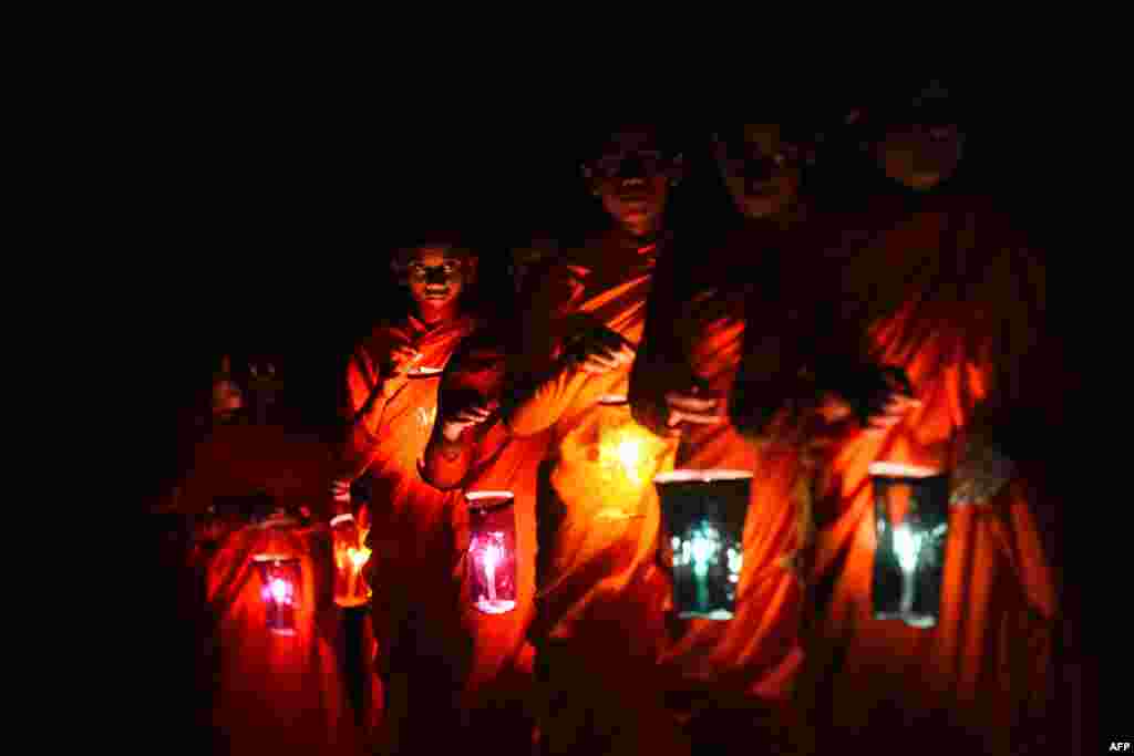 Buddhist nuns light paper lanterns on Vesak day, a festival also known as Buddha Jayanti, to commemorate the birth, enlightenment, and death of Gautama Buddha, at the Dekanduwala Bhikkhuni training center in Horana, Sri Lanka.