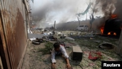 A wounded man lies on the ground at the site of a blast in Kabul, Afghanistan, May 31, 2017. 