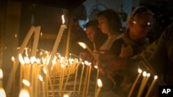 Christian worshipers light candles at the Church of the Nativity, traditionally believed by Christians to be the birthplace of Jesus Christ, ahead of Christmas, in the West Bank city of Bethlehem, Dec. 17, 2017. 