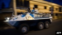 A United Nations armored personnel carrier patrols through the city of Goma following the sound of shell fire and gunshots, November 19, 2012. 