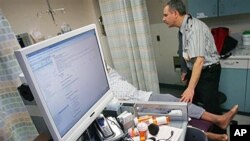Dr. Jacob Khushigian checks on a patient who had overdosed - also showing his computer data base that lets doctors know what drugs their patients already are taking - shown in a Kaweah Delta Emergency Room in Visalia, California, February 2010. (file phot
