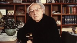 Aaron Copland at home in his library