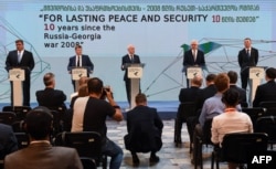 Jacek Czaputowicz (2-R) and Latvia's Foreign Minister Edgars Rinkevics (R) hold a briefing following a round table meeting in Tbilisi, Georgia, on August 7, 2018, a day ahead of the 10th anniversary of the start of the brief war between Russia and Georgia over control of South Ossetia.