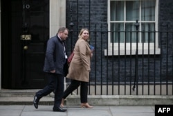 Britain's Northern Ireland Secretary Karen Bradley (R) leaves 10 Downing Street after attending a Brexit sub-committee meeting in central London, Feb. 8, 2018.