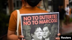 A demonstrator holds a poster during a protest following the presidential bid announcement of Ferdinand “Bongbong” Marcos Jr., son of late dictator Ferdinand Marcos, at the Commission of Human Rights, in Quezon City, Metro Manila, Philippines, Oct. 6, 202