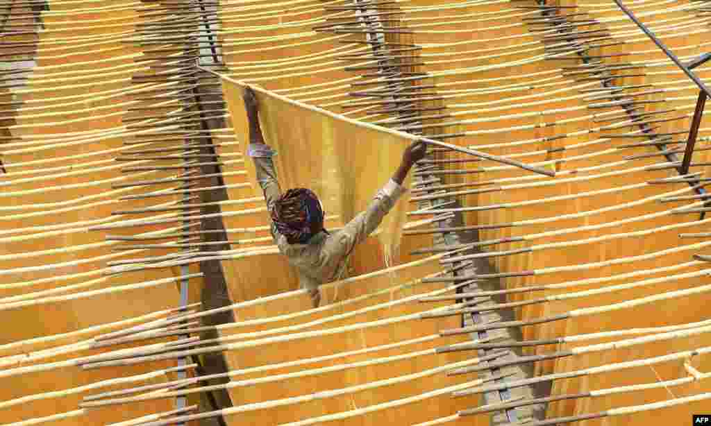 A Pakistani man dries Seviiyan (thin vermicelli), which is used for the preparation of 'sheerkhurma' — a traditional sweet dish prepared by the Muslim community during the holy month of Ramadan, at a factory in Lahore.