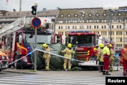 Rescue personnel cordon the area where several people were stabbed, at Turku Market Square, Finland, Aug. 18, 2017.