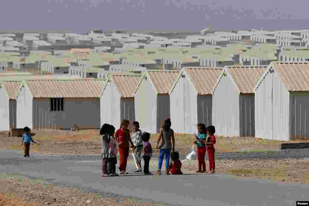 Syrian refugee children play in front of their family residences at Azraq refugee camp near Al Azraq, east of Amman, Jordan, Aug., 2014. 