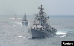 FILE - Indian naval warships are seen in the waters off the southern Indian port of Chennai.