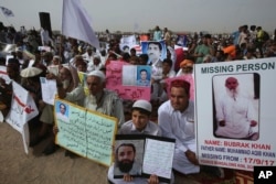 Members and supporters of the Pashtun Protection Movement hold pictures of missing family members during a rally in Karachi, Pakistan, May 13, 2018.
