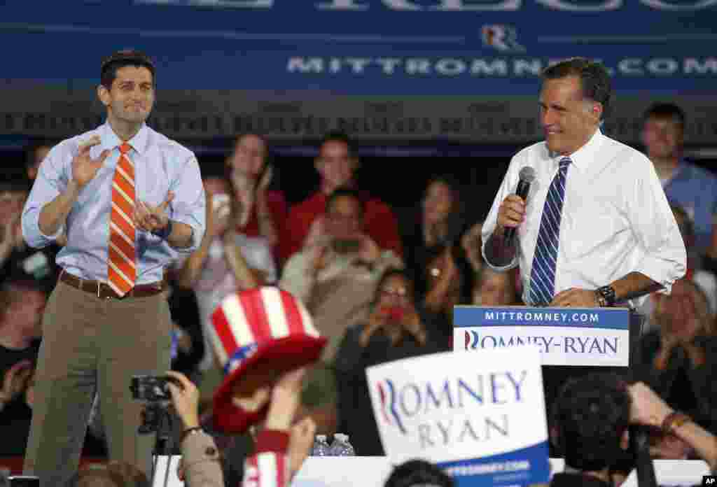 Republican presidential candidate former Massachusetts Gov. Mitt Romney, right, speaks during a campaign event along with his vice presidential running mate Rep. Paul Ryan, R-Wis., left, at the Celina High School gymnasium in Celina, Ohio, October 28, 2012.