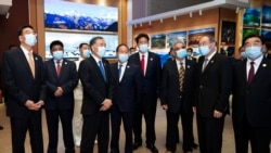 In this photo released by Xinhua News Agency, Wang Yang, third from left, is escorted by officials as he visits to a museum period of the ceremony to commemorate the 70th anniversary of Tibet liberation, in Lhasa in western China's Tibet Autonomous Region