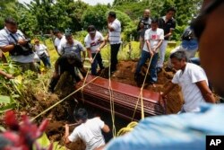 Friends and family bury 15-year-old Erick Jimenez Lopez in Masaya, Nicaragua, July 18, 2018. Jimenez Lopez was killed as government forces retook the symbolically important neighborhood of Monimbo, which had recently become a center of resistance to President Daniel Ortega's government.