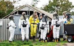 Employees from the Danish Veterinary and Food Administration and the Danish Emergency Management Agency in protective equipment are seen amid the coronavirus disease (COVID-19) outbreak at a mink farm in Gjoel, North Jutland, Denmark October 8, 2020.