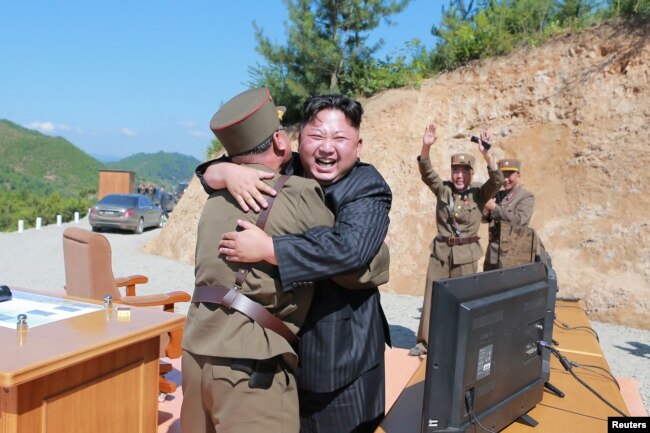 North Korean leader Kim Jong Un reacts with scientists and technicians of the DPRK Academy of Defence Science after the test-launch of the intercontinental ballistic missile Hwasong-14 in this undated photo released by North Korea's Korean Central News Agency, July 5, 2017.