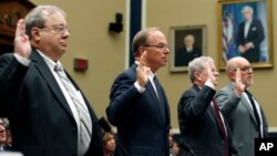 Dr. Joseph Mastandrea, left, chairman of the board, Miami-Luken, John Hammergren, chairman, president, and CEO, McKesson, J. Christopher Smith, former president and CEO, H.D. Smith Wholesale Drug, and Steven Collis, chairman, president, and CEO, AmerisourceBergen, are sworn in before they testify during a hearing of the Committee on Energy and Commerce, Subcommittee on Oversight and Investigations, about the opioid epidemic, on Capitol Hill, May 8, 2018 in Washington. 