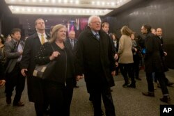 Democratic presidential candidate Bernie Sanders and his wife, Jane, walk in Times Square on their way to see the Broadway show "Hamilton" in New York, April 8, 2016.