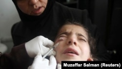 A doctor treats a child showing symptoms of Leishmaniasis at a hospital in Aleppo, February 11, 2013. 