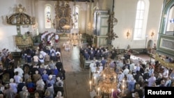 FILE - A memorial service is held at Oslo Cathedral, as Norway marked the fourth anniversary of the 2011 attacks, in Oslo, July 22, 2015. 