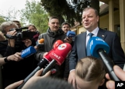 Lithuanian Prime Minister and presidential candidate Saulius Skvernelis speaks to the media at a polling station during the first round of voting in presidential elections in Vilnius, Lithuania, May 12, 2019.