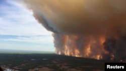 The Chuckegg Creek wildfire burns out of control in the High Level Forest Area, to the southwest and west of the town of High Level, Alberta, Canada in this May 19, 2019, picture obtained from social media. 