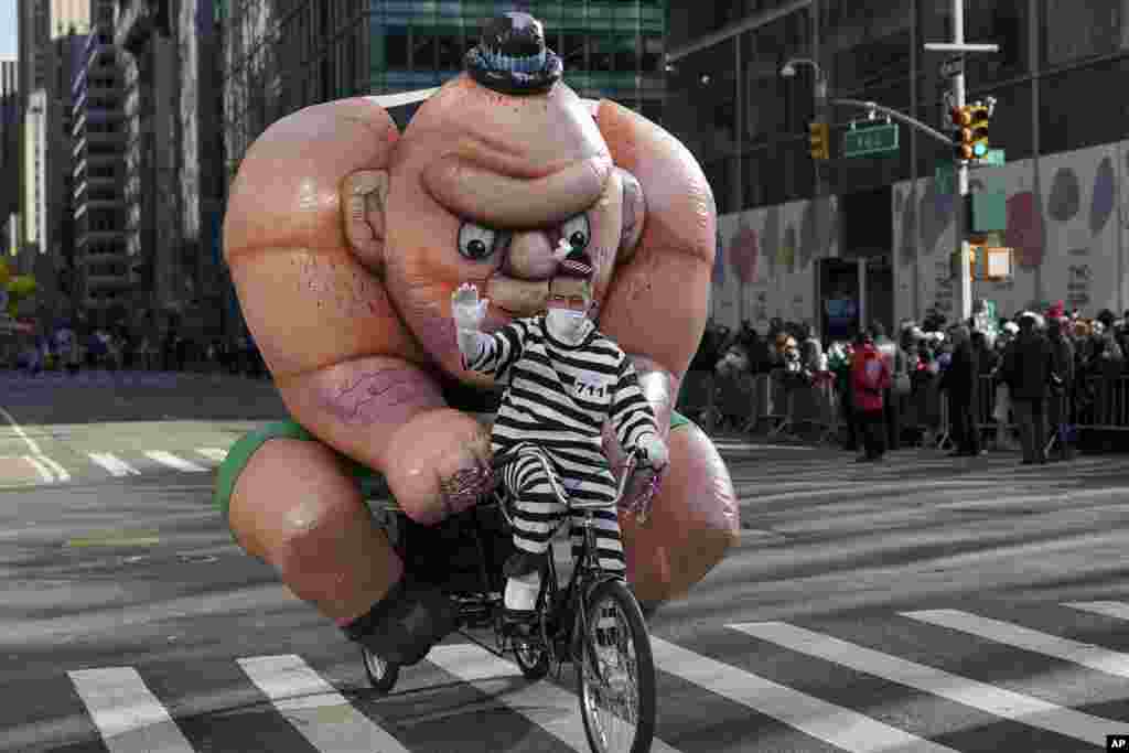 The Tough Guy balloon is driven down Sixth Avenue on a bicycle during the Macy&#39;s Thanksgiving Day Parade in New York.