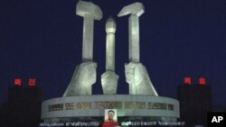 North Koreans gather to pay respects to their late leader Kim Jong Il in front of a monument to mark the founding of Workers' Party in Pyongyang, North Korea, December 22, 2011.