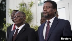 Haiti's provisional president Jocelerme Privert (L) and appointed prime minister Fritz Jean listen to the national anthem at Jean's inauguration ceremony in the National Palace in Port-au-Prince, Haiti, Feb. 26, 2016. 