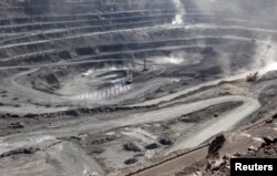 FILE - Miners are seen at the Bayan Obo mine containing rare earth minerals, in Inner Mongolia, China, July 16, 2011.