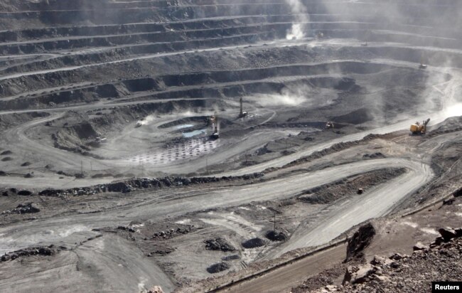 FILE - Miners are seen at the Bayan Obo mine containing rare earth minerals, in Inner Mongolia, China, July 16, 2011.