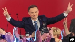 Opposition candidate Andrzej Duda celebrates with supporters his victory, as first exit polls in the presidential runoff voting are announced in Warsaw, Poland, May 24, 2015.