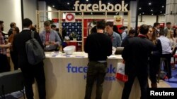 FILE - People stop at the Facebook booth at the Conservative Political Action Conference (CPAC) at National Harbor, Maryland, U.S., Feb. 23, 2018. 