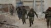 FILE - A rebel fighter runs with a weapon on the outskirts of the northern Syrian town of al-Bab, Syria, Jan. 26, 2017. 