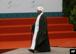 FILE - Sudan's President Omar al Bashir walks to the stage before a group photo session at the Organization of Islamic Cooperation summit in Jakarta, Indonesia, March 7, 2016.