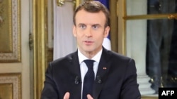 French President Emmanuel Macron speaks during a special address to the nation, his first public comments after four weeks of nationwide 'yellow vest' (gilet jaune) protests, Dec. 10, 2018, at the Elysee Palace, in Paris.