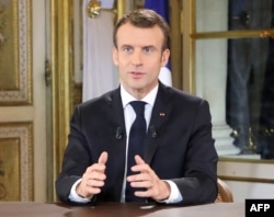 French President Emmanuel Macron speaks during a special address to the nation, his first public comments after four weeks of nationwide 'yellow vest' (gilet jaune) protests, Dec. 10, 2018, at the Elysee Palace, in Paris.