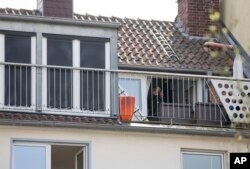 Police search an apartment where the man who steered his car into a crowd a day before lived, in Muenster, Germany, April 8, 2018.