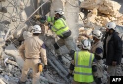 FILE - Syrian civil defense teams work on the rubble of a building in Idlib, in northwestern Syria, on Dec. 21, 2015, following reported Russian airstrikes.