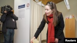 FILE - Left-Green Movement candidate Katrin Jakobsdottir casts her vote during a snap parliamentary election in Reykjavik, Iceland, Oct. 28, 2017. Jakobsdottir will be Iceland's next prime minister.