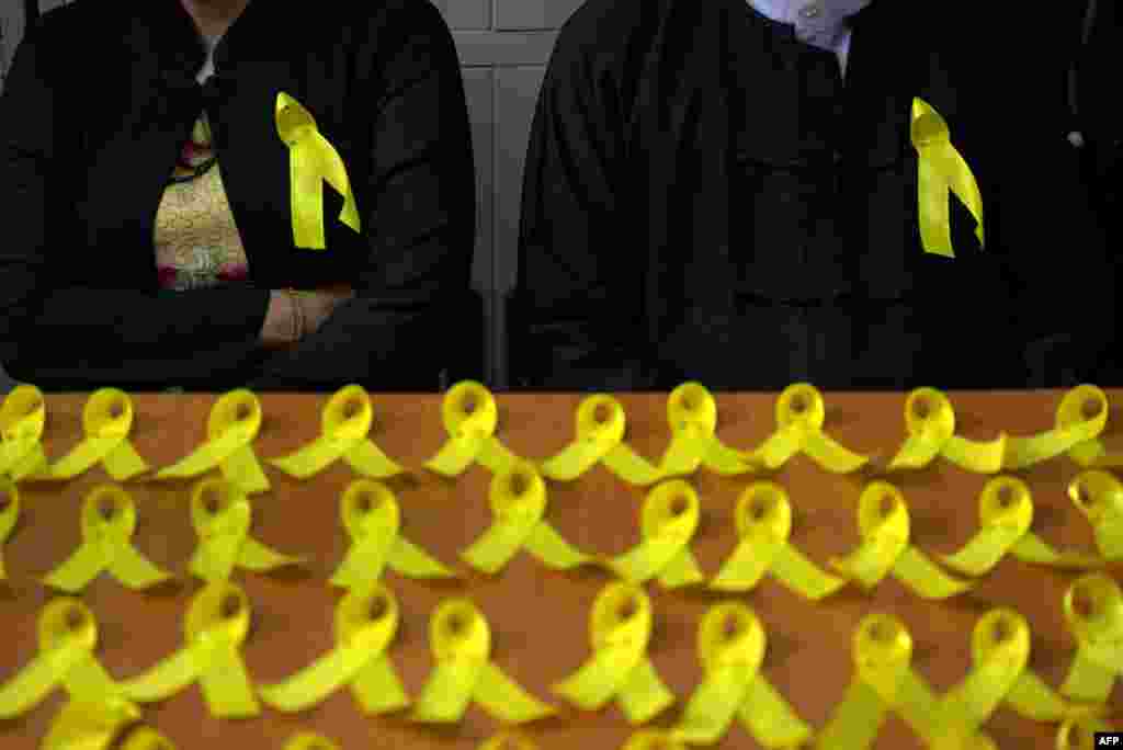 Myanmar lawyers wear yellow ribbons pinned to their jackets, a new symbol of defiance as public servants increasingly voice opposition to the military's dominance of public services, as part of a campaign in Yangon.
