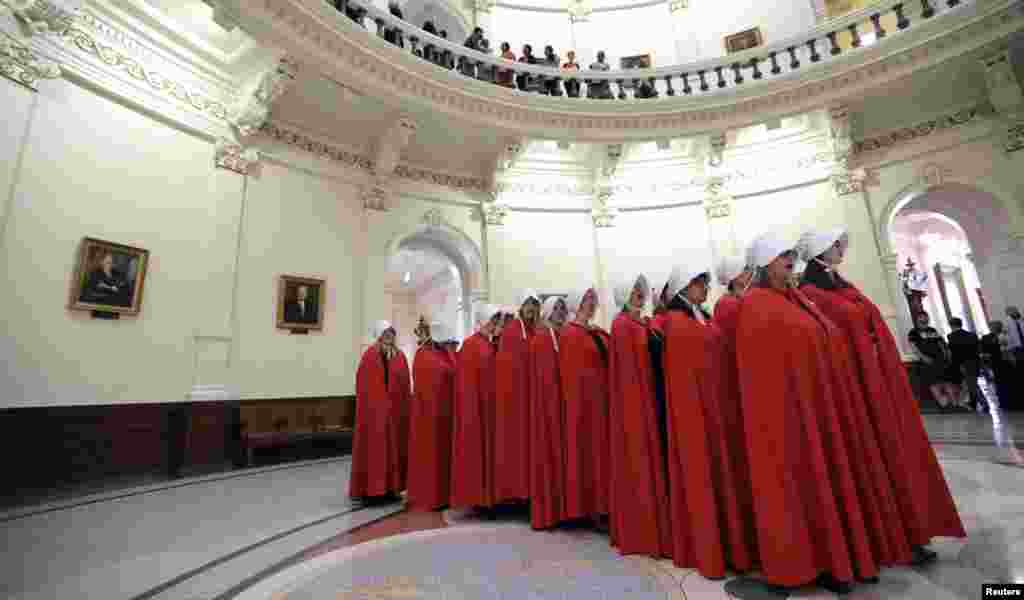 Activists dressed as characters from &quot;The Handmaid&#39;s Tale&quot; chant in the Texas Capitol Rotunda as they protest SB8, a bill that would require health care facilities, including hospitals and abortion clinics, to bury or cremate any fetal remains whether from abortion, miscarriage or stillbirth, and they would be banned from donating aborted fetal tissue to medical researchers, in Austin, May 23, 2017.