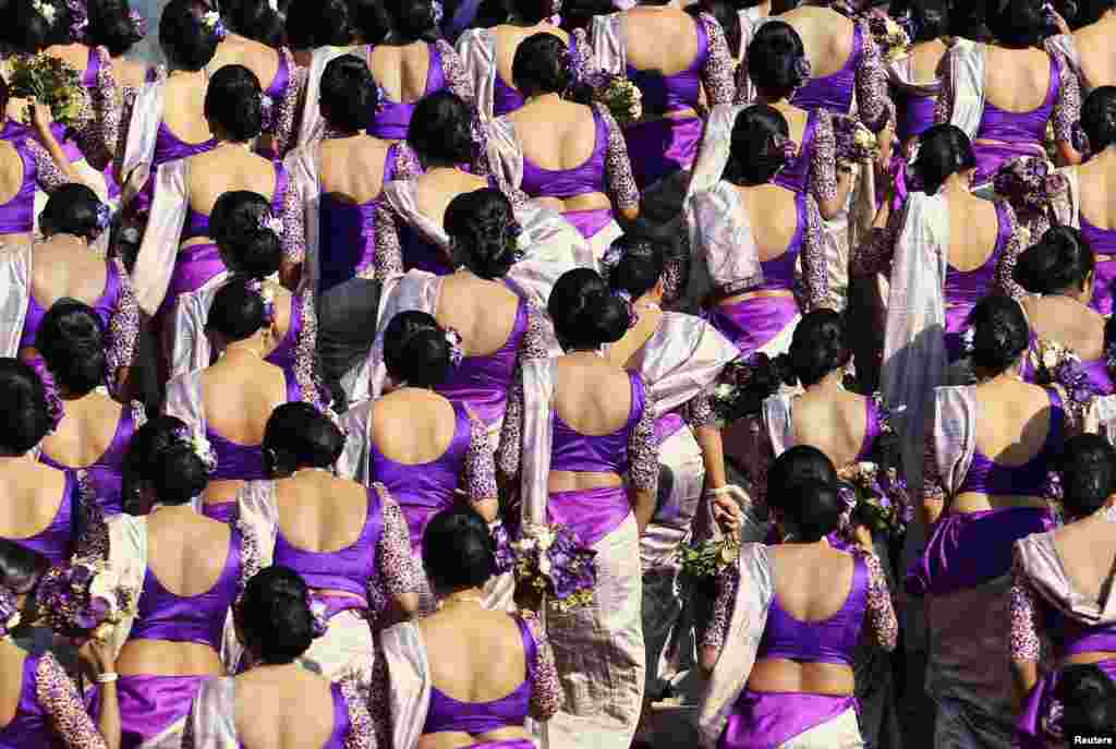 Bridesmaids pose for a photo during a wedding ceremony for Sri Lankan couple Nisansala and Nalin as they break the Guinness record for a wedding with the most bridesmaids for a bride in Negombo. Up to 126 bridesmaids, 25 best men, 20 page boys and 23 flower girls attended the ceremony.