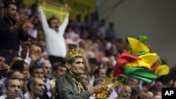 The supporters of the pro-Kurdish Peace and Democracy Party wave their flags during the party's congress in Ankara, Turkey, Sunday, Sept. 4, 2011.