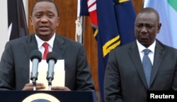 FILE - Kenyan President Uhuru Kenyatta, left, appears with his deputy, William Ruto, at a news briefing.
