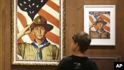 FILE - An 11-year-old boy looks over a Boy Scout-themed Norman Rockwell exhibition at the Church History Museum in Salt Lake City, Utah, July 22, 2013.